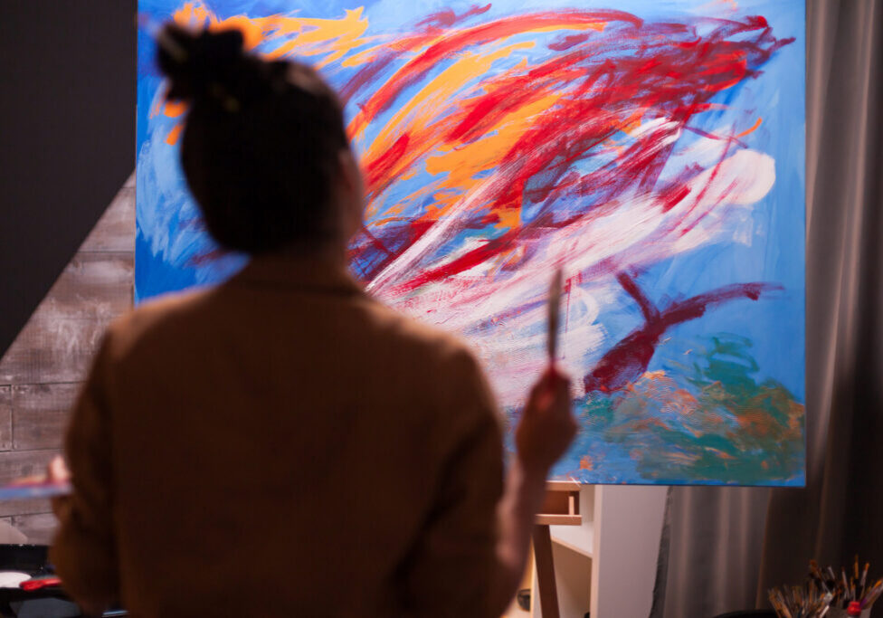 Painter in art workshop looking at painting composition in art studio. Modern artwork paint on canvas, creative, contemporary and successful fine art artist drawing masterpiece